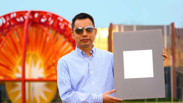 Xiulin Ruan and a sample of his cooling paint.