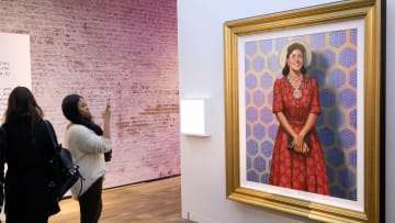 Guests look at a portrait of Henrietta Lacks.