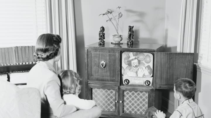 A vintage family enjoys the hit show of the day, 'Scary Clown Time.'